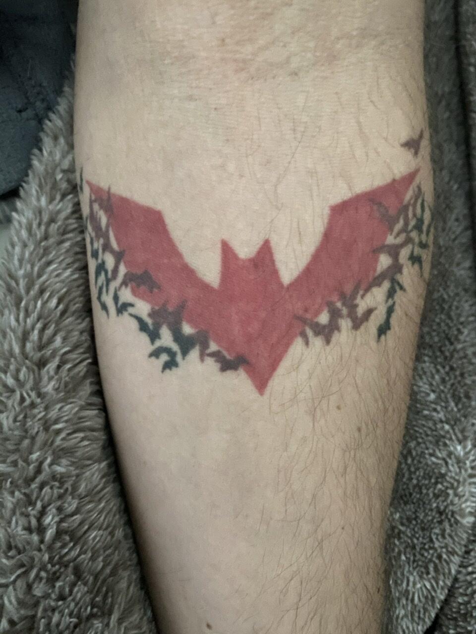 Batman logo tattoo hand poked on the achilles,
